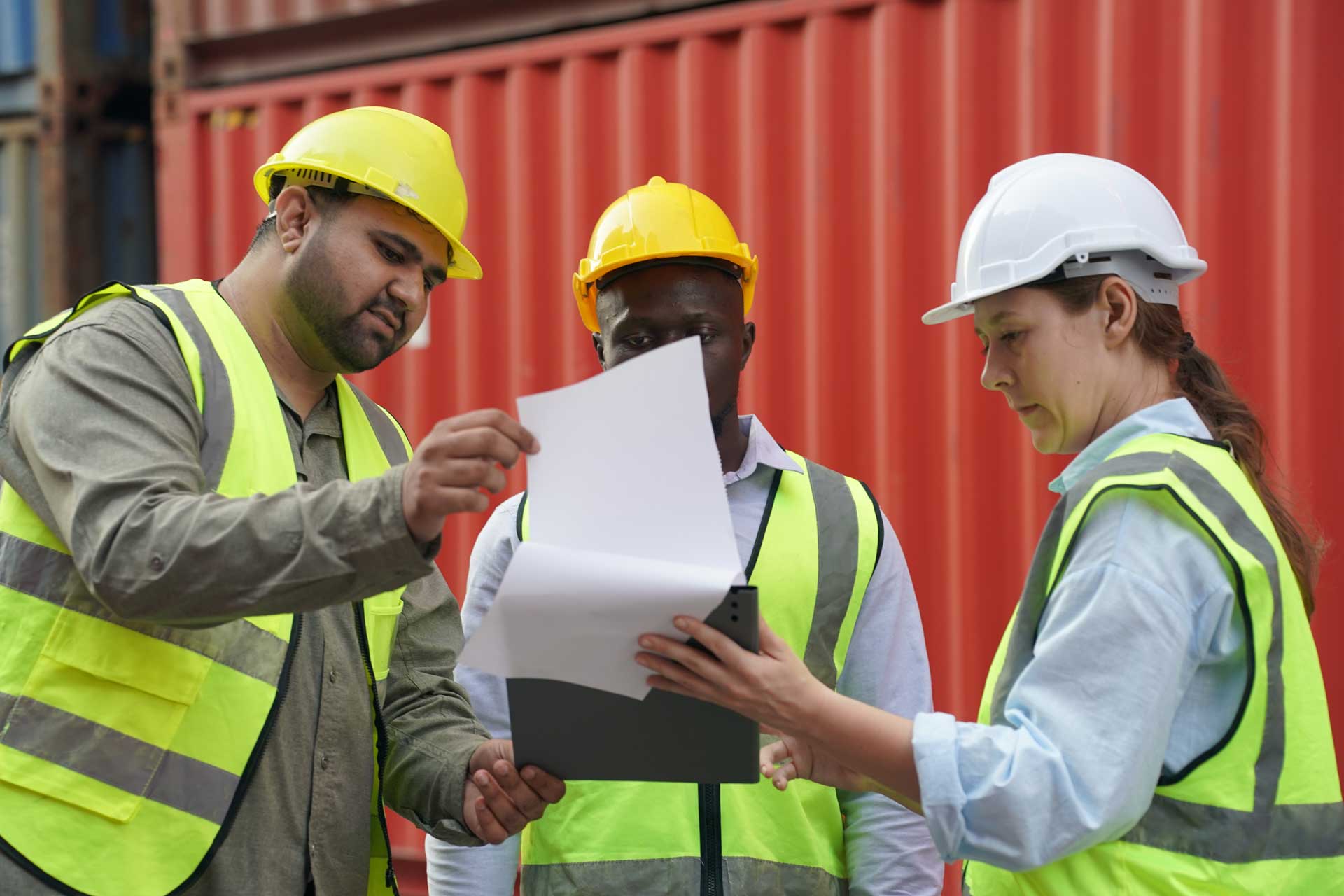 Three employees with hard hats