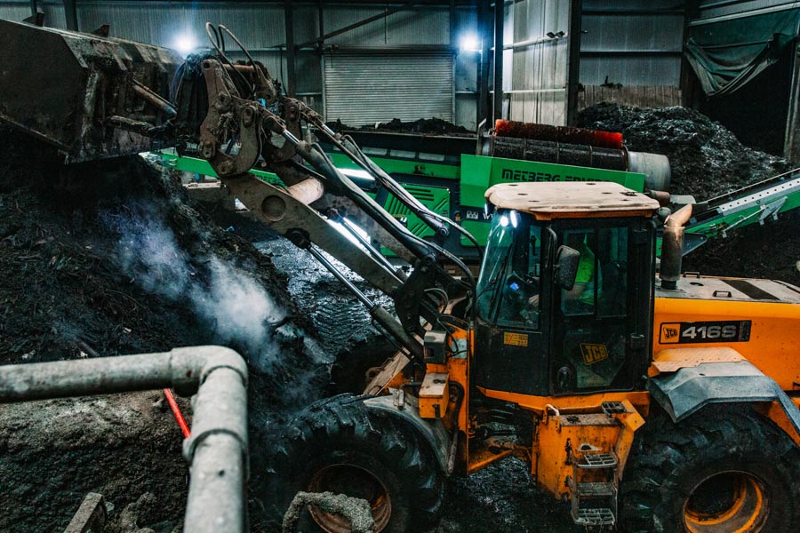 Digger in the waste facility